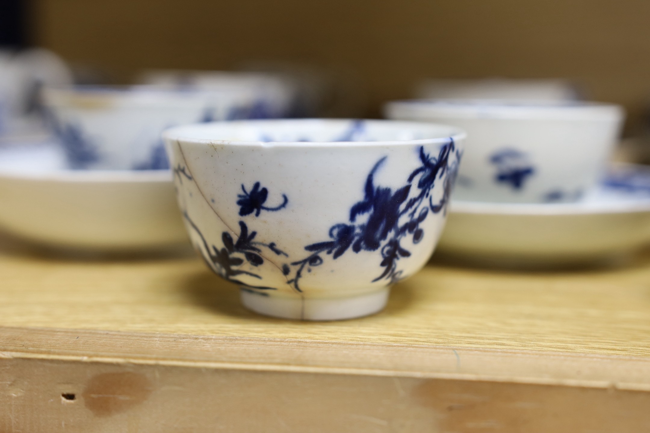 A large group of 18th century Worcester, Caughley and Liverpool blue and white tea bowls, coffee cups and saucers etc. including a Bow Cross-Legged Man